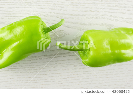 Fresh raw light green pepper on grey wood Fresh raw light green pepper on grey wood 42068435