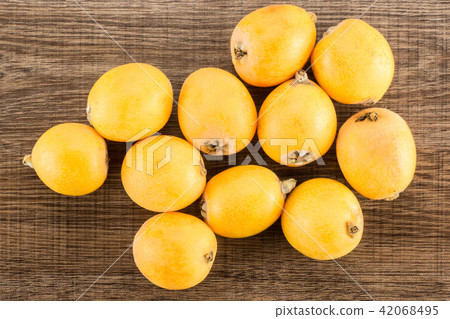 Fresh raw orange japanese loquat on brown wood 42068495
