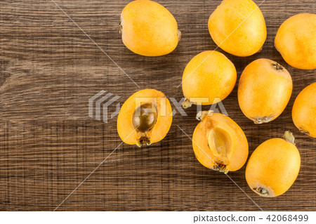 Fresh raw orange japanese loquat on brown wood 42068499