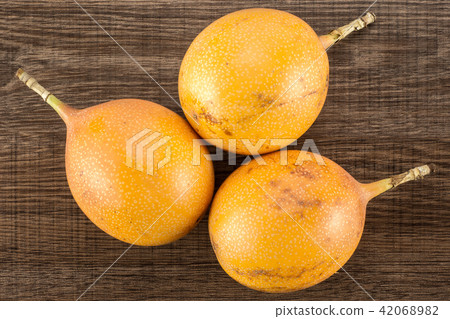 Fresh raw Grenadilla on brown wood 42068982