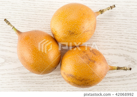 Fresh raw Grenadilla on grey wood Fresh raw Grenadilla on grey wood 42068992