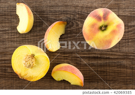 Fresh Raw yellow peach on brown wood Fresh Raw yellow peach on brown wood 42069385
