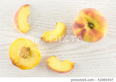 Fresh Raw yellow peach on grey wood 42069397