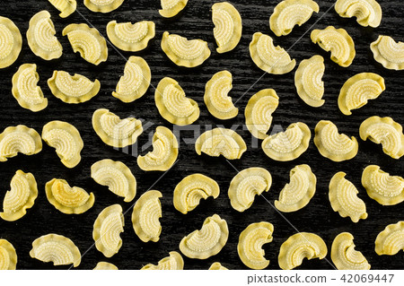 Fresh raw paste Creste di Gallo on black wood Fresh raw paste Creste di Gallo on black wood 42069447