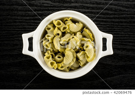 Fresh raw paste Creste di Gallo on black wood 42069476