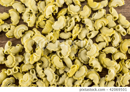 Fresh raw paste Creste di Gallo on brown wood Fresh raw paste Creste di Gallo on brown wood 42069501