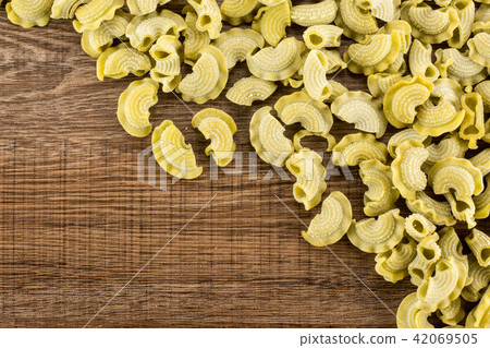 Fresh raw paste Creste di Gallo on brown wood Fresh raw paste Creste di Gallo on brown wood 42069505