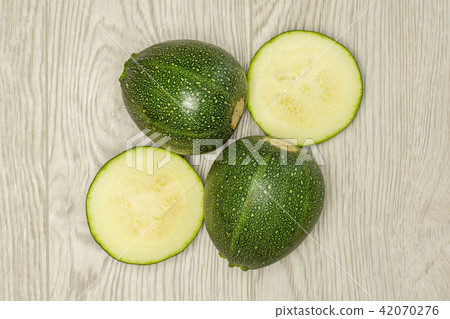 Fresh raw round Zucchini on grey wood Fresh raw round Zucchini on grey wood 42070276