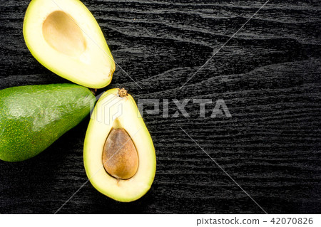 fresh Raw smooth avocado on black wood fresh Raw smooth avocado on black wood 42070826