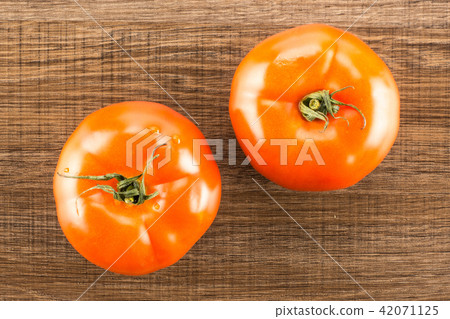 Fresh raw Tomato (La Parcela) on black wood Fresh raw Tomato (La Parcela) on black wood 42071125