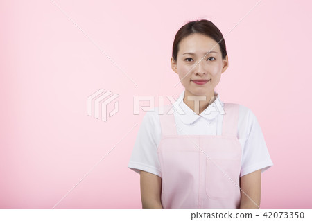 A woman smiling with a white coat A woman smiling with a white coat 42073350