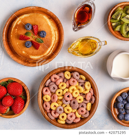 Breakfast with colorful cereal rings, pancakes Breakfast with colorful cereal rings, pancakes 42075295