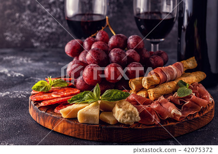 Prosciutto, sausage, wine, grape, parmesan Prosciutto, sausage, wine, grape, parmesan 42075372