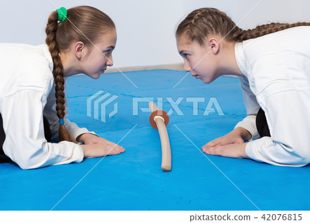 Two girls in hakama bow on Aikido training Two girls in hakama bow on Aikido training 42076815