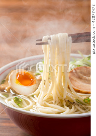 Picking hot salt noodles with chopsticks Picking hot salt noodles with chopsticks 42077478