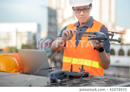 Asian man using drone and laptop for site survey 42078935