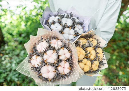 three beautiful and different bouquets lavender with cotton in woman hands . dried flowers lilac 42082075