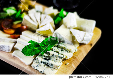set of different cheeses on a wooden board 42082765