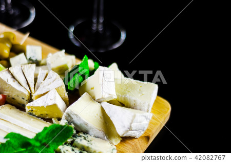 set of different cheeses on a wooden board 42082767