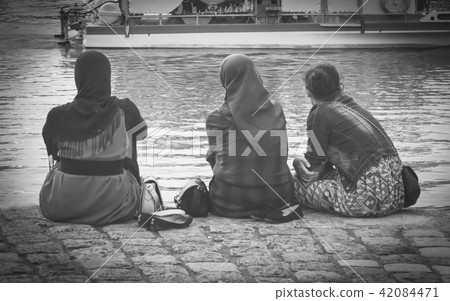 Muslim woman wearing hijab looking on the ocean Muslim woman wearing hijab looking on the ocean 42084471