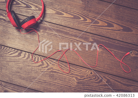 Headphones on an old wooden table Headphones on an old wooden table 42086313