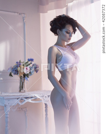Woman in lingerie at the window 42087372