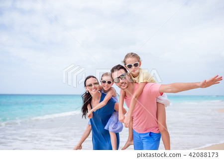 Happy beautiful family on the beach Happy beautiful family on the beach 42088173