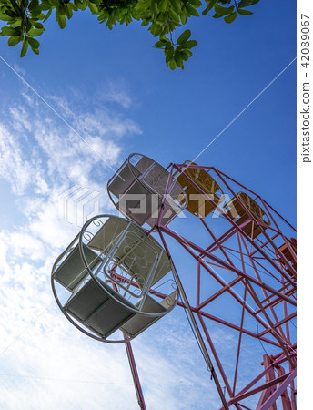 close up part of pastel ferris wheel on blue sky close up part of pastel ferris wheel on blue sky 42089067