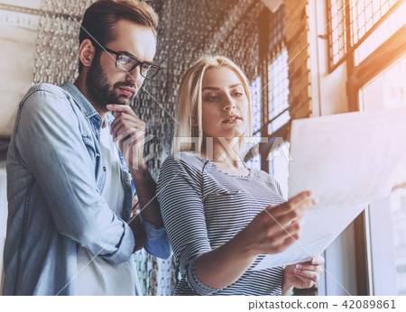 Business Couple in Casual Wear Discussing Document Business Couple in Casual Wear Discussing Document 42089861