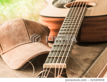 The bridge of an acoustic guitar with a cloth cap 42089948