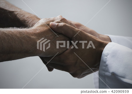 man holding the hands of a senior man man holding the hands of a senior man 42090939