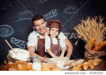 Little girl with father making dough 42092587