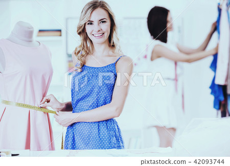 Clothing Designer Working with Fabric in Showroom. 42093744