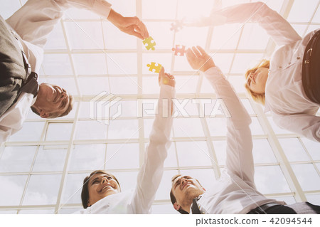 Closeup Hand of People Connecting Jigsaw Puzzle 42094544