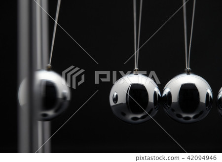 Closeup Of Newton Balls With Swinging Metal Spheres Closeup Of Newton Balls With Swinging Metal Spheres 42094946