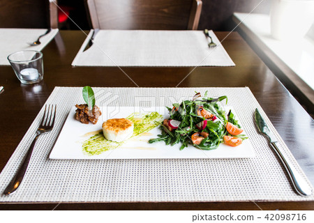 Healthy vegetable summer salad, fresh vegetables and dressing with grilled cheese flambe arranged on Healthy vegetable summer salad, fresh vegetables and dressing with grilled cheese flambe arranged on 42098716