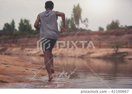 Black men runner are running at Riverside.black man doing workou 42100667