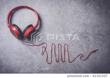 Red headphones on stone background 42101507