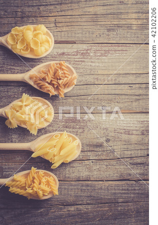 Mix of pasta on an old wooden table Mix of pasta on an old wooden table 42102206