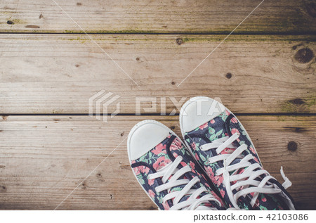 Colorful sneakers on wooden floor Colorful sneakers on wooden floor 42103086