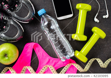 Fitness equipment on dark background Fitness equipment on dark background 42103095