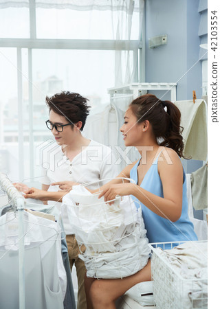 Young couple in laundry room 42103554