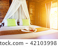 White towel and Chinese rose on bed 42103998