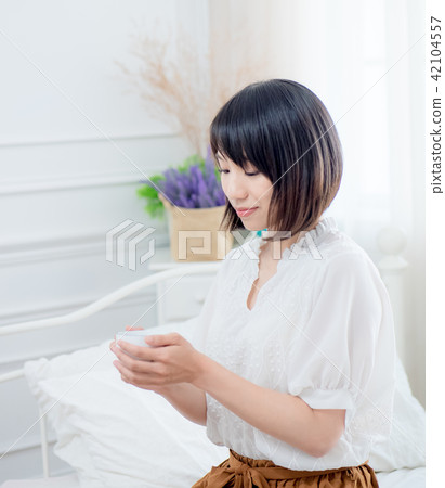 beautiful young woman drinking coffee on bed beautiful young woman drinking coffee on bed 42104557