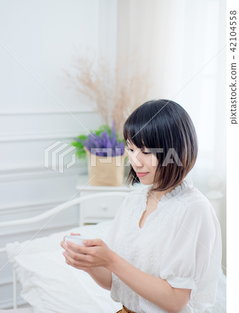 beautiful young woman drinking coffee on bed beautiful young woman drinking coffee on bed 42104558