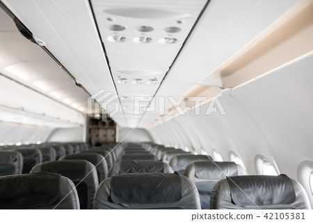Empty airplane seats in the cabin. Modern Airplane seats in perspective. Transportation concept 42105381
