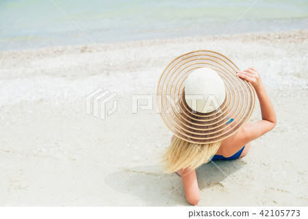 Holiday bikini girl relaxing from behind on beach Holiday bikini girl relaxing from behind on beach 42105773