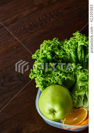 Healthy lunch prepared in small plastic container, top view, close-up. 42105983