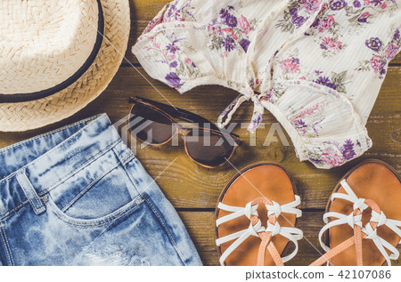 Women outfit on an old wooden table Women outfit on an old wooden table 42107086