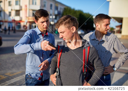 Portrait of a group of smiling friends, preparing for making selfie on camera on urban background. Portrait of a group of smiling friends, preparing for making selfie on camera on urban background. 42108725